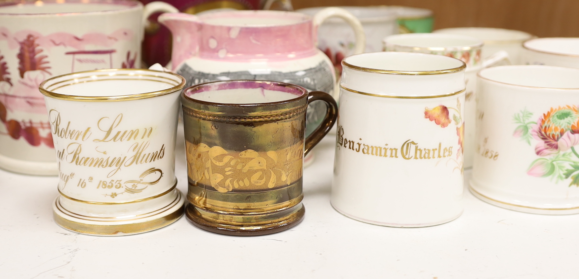A group of 19th century Staffordshire christening mugs and pink lustre wares